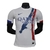 camisa-reserva-psg-número-ii-away-2024-2025-branca-torre-eiffel-desenho-artístico-azul-marinho-vermelho-gola-redonda-punhos-bandeira-frança-modelo-jogador