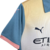 Camisa-Manchester-City-Away-202da-Etihad-Airways-24-25-away-torcedor-gola-puma-haland-azul-rosa-verde