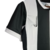 Camisa do Corinthians 24/25 Torcedor Away em preto e branco, destacando o design das mangas e o logo da marca.