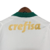 Camiseta branca com detalhe verde e o nome "crefisa" em dourado na parte de trás.