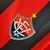 Emblema da camisa do time Vitória, com cores vermelha e preta, destacando uma estrela amarela.