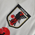 Emblema da seleção japonesa de futebol, destacando o logo da JFA em fundo branco com detalhes em preto.