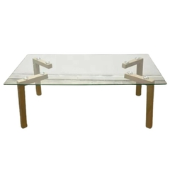 Mesa de vidrio rectangular con patas de madera y soportes de diseño moderno.