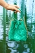green bag made of exotic pirarucu skin from the Amazon